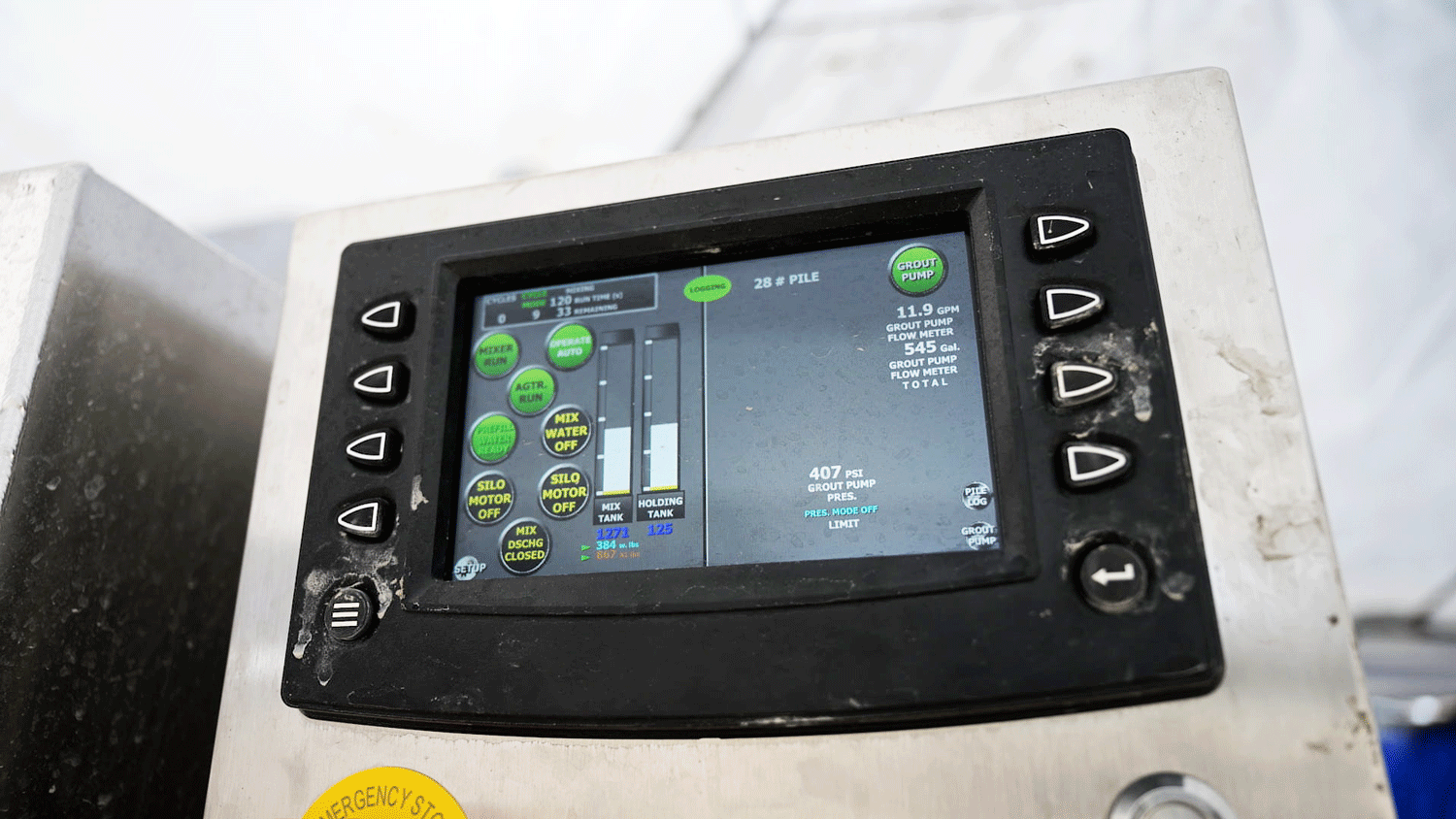 Intric AMS500 fully automated mixing station touchscreen control panel showing live grout pump flow, pressure, tank levels, and batch data logging on jobsite