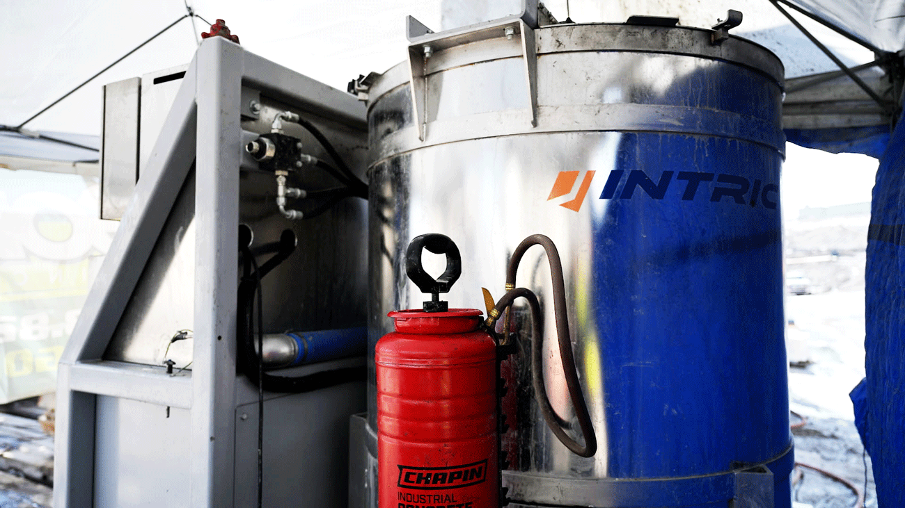 Alt tag: Made in the USA Intric AMS500 fully automated mixing station stainless steel storage tank and frame with jobsite safety equipment, available for rent or purchase from National Piling Products