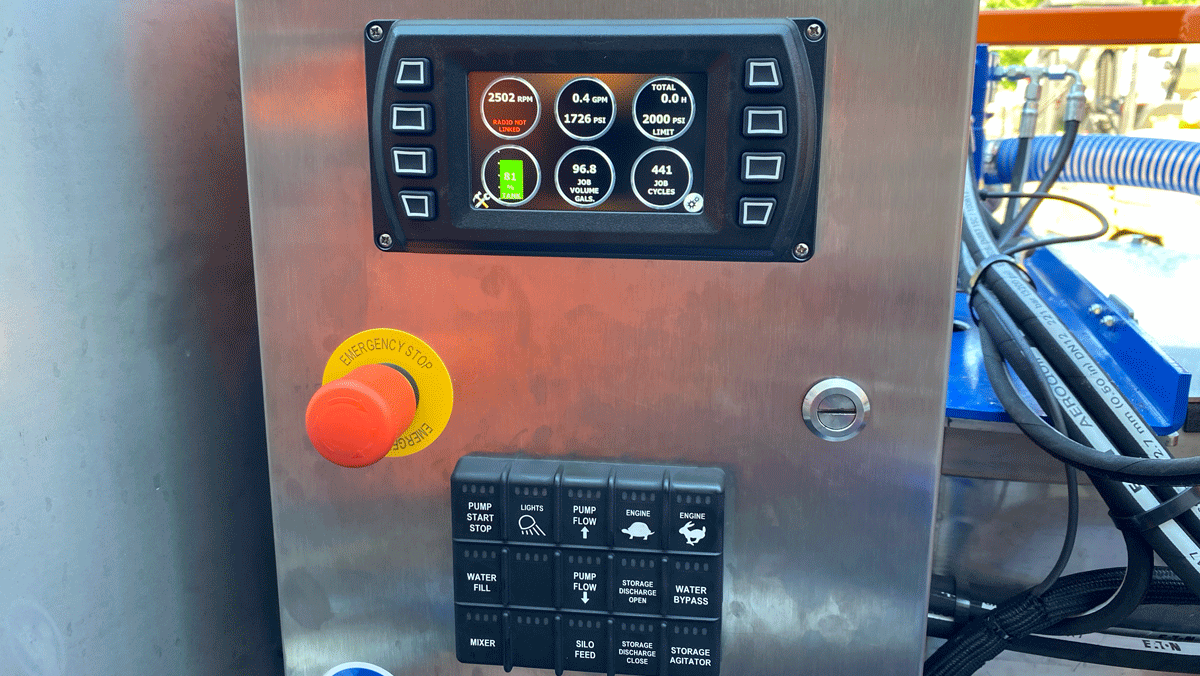 Intric D-12 grout plant digital control panel with emergency stop button and display monitoring pump flow, pressure, RPM, and grout volume