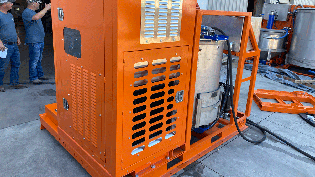 Intric D-12 grout plant diesel power pack enclosure and stainless steel mixing tank on skid frame at National Piling Products yard