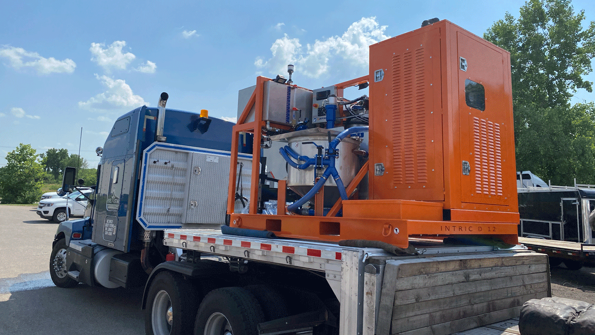Intric D-12 high shear colloidal grout plant loaded on flatbed semi truck for delivery from National Piling Products