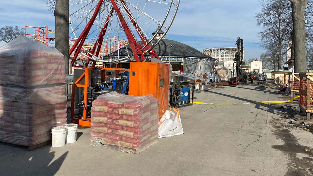 Intric D-12 high shear colloidal grout plant from National Piling Products on amusement park ride foundation project with ferris wheel and bagged cement