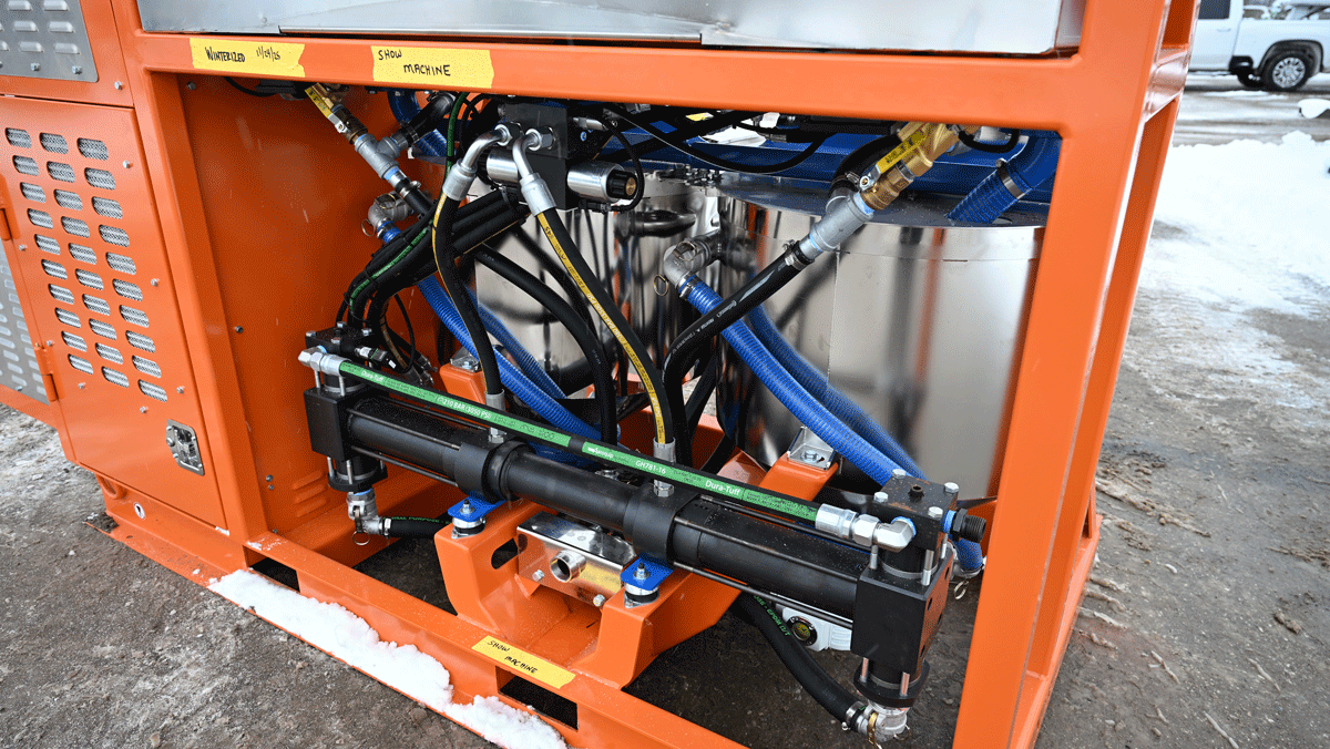 Hydraulic cylinder, hoses, and stainless tanks on Intric D9 grout plant frame at National Piling Products yard