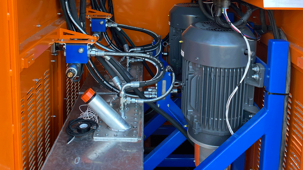 Made in the USA Intric DT650 mixing station enclosed power module showing twin 30 HP electric motors, hydraulic oil tanks, and controls, available for rent or sale from National Piling Products