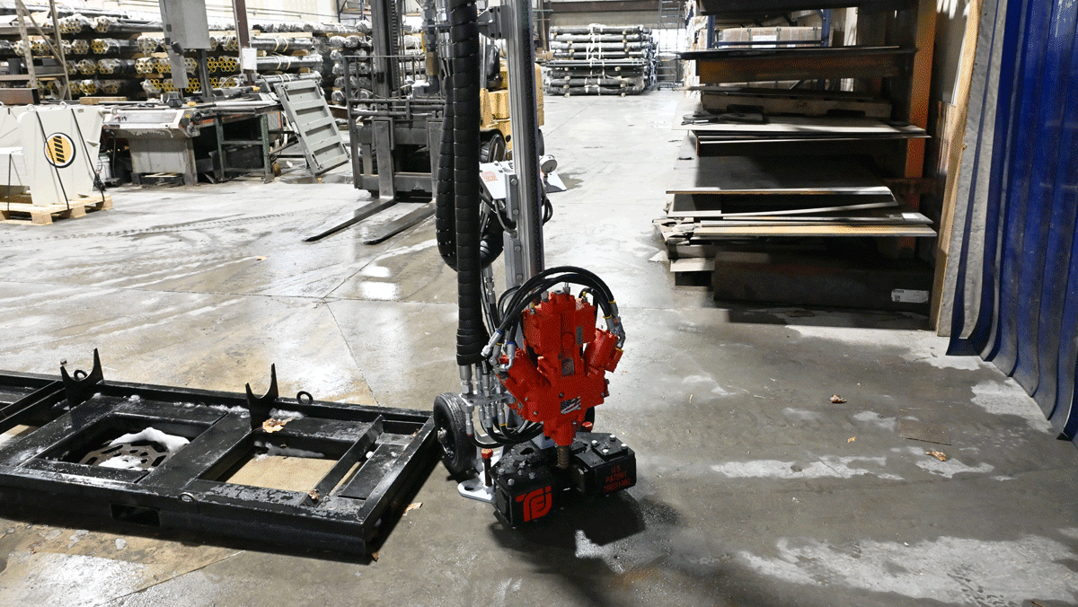 Alt text: American-made TEI MP260 man-portable drilling system with TEI 260 head set up inside National Piling Products shop for limited-access micropile and anchor work