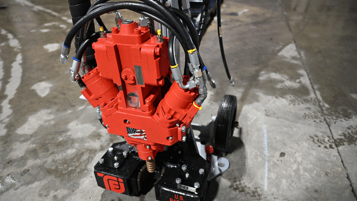Close-up of American-made TEI MP260 man-portable drilling system with TEI 260 HT drifter, hydraulic hoses, and patented base showing U.S. patent number for limited-access micropile and soil nail drilling
