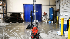 Full-height American-made TEI MP260 man-portable drilling system set up in National Piling Products shop, showing slim mast and compact base for limited-access micropile and anchor work