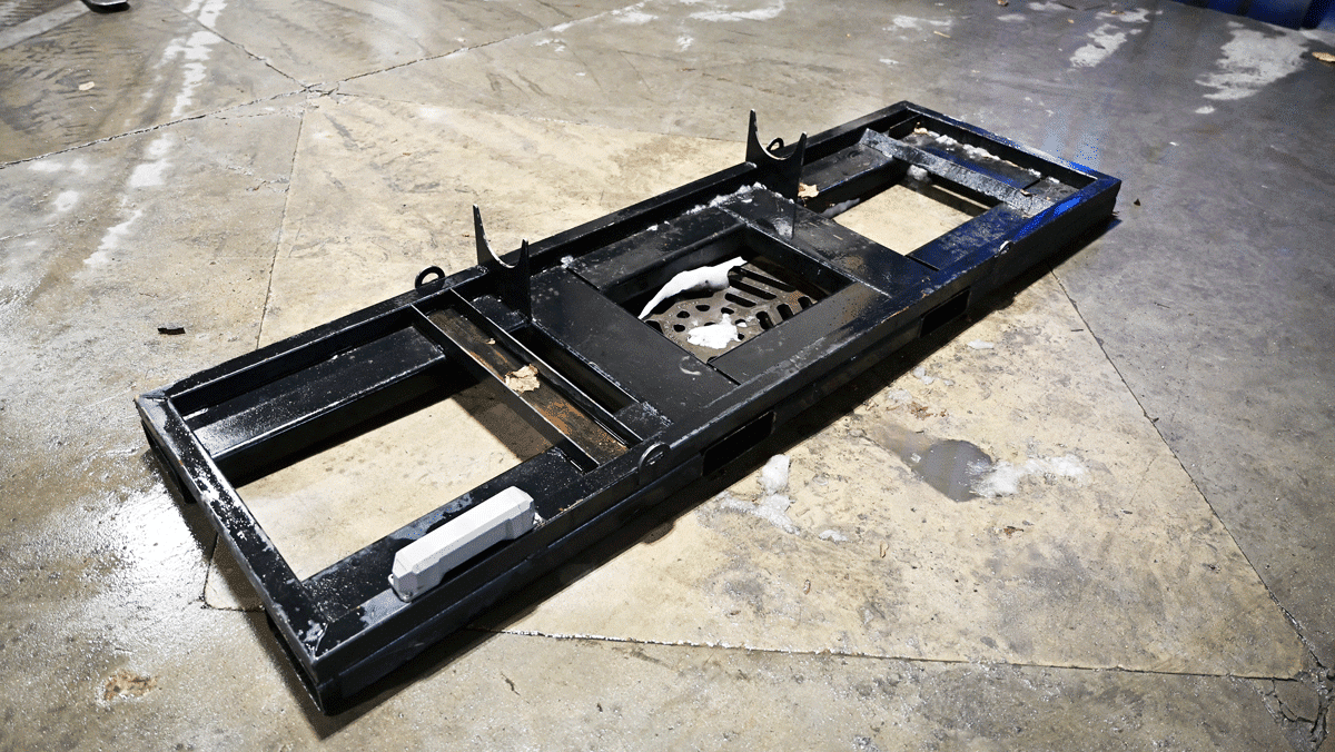 TEI MP260 portable drilling system base frame for skid steer or carrier mounting, shown on shop floor ready to accept the American-made man-portable drill mast