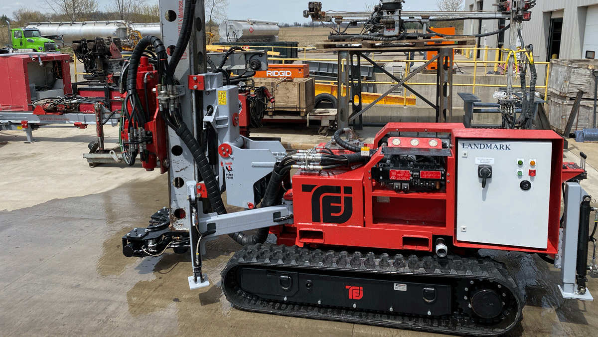 TEI TD‑100 electric‑hydraulic limited‑access drill rig staged outside a shop, showing compact tracks, mast, and control panel before mobilization.