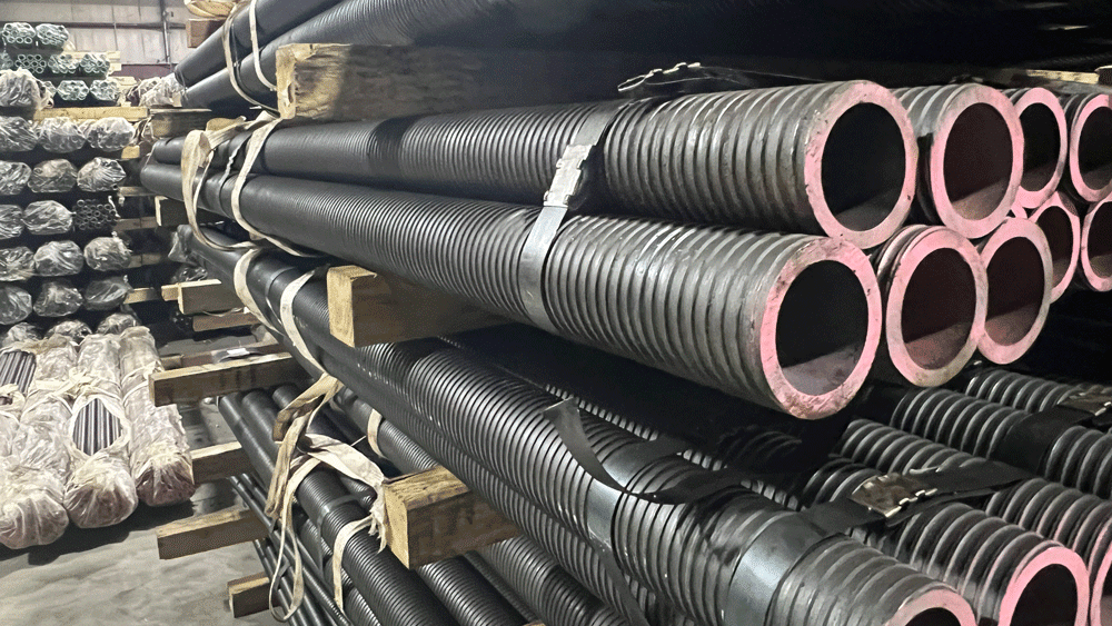 Bundles of hollow bar stocked on racks inside the National Piling Products warehouse.